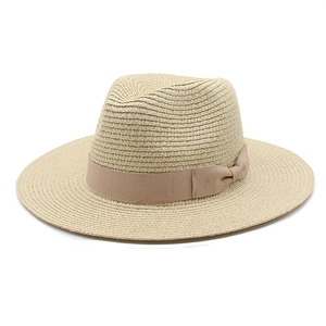 Detail of hand-woven straw fedora hat featuring a beige sun-shading wide brim and ribbon