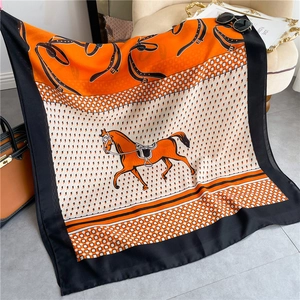 Orange cotton feel scarf with equestrian horse pattern and fashion accessories display