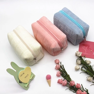 Quilted plush pencil cases in white, pink, and blue with fluffy textures and zippers