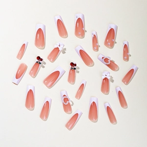 French tip press-on nails with cherry accents, white bows and pearl heart designs