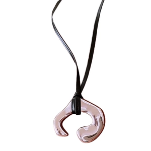 Irregular silver metal pendant with black adjustable faux leather cord on white background