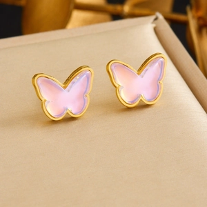 Pink butterfly stud earrings with gold frame on textured surface for women