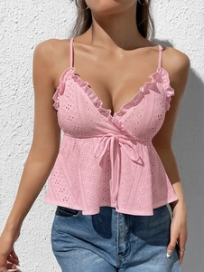 Close-up of pink lace camisole featuring delicate floral patterns and ruffled hem details