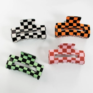 Set of four checkered claw clips in black, orange, green, and pink for women