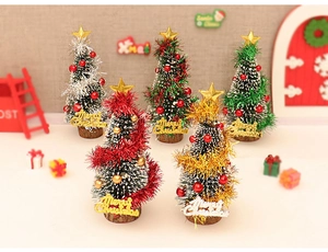 Miniature snowy Christmas tree models with star toppers and Merry Christmas signs on wood base