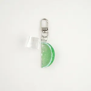 Detailed close-up of a realistic lime slice and resin ice cube charm with silver lobster clasp