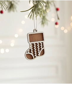 Close-up of a carved wooden Christmas stocking ornament with detailed wood grain texture
