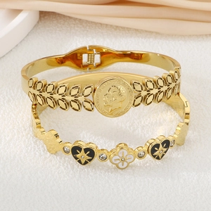 Detail of 18K gold-plated bracelets featuring coin relief, heart, and clover motifs