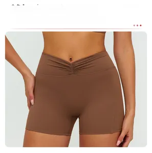 Detail of high waisted yoga shorts with ruched V-shaped waistband and matte brown fabric