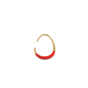 Detailed macro view of 18K gold U-shaped earring featuring vibrant red enamel inlay