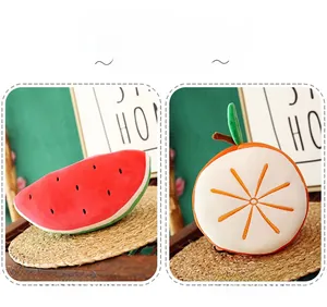 Detail of plush watermelon and orange fruit pillows with soft texture and bright colors