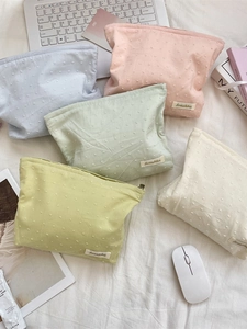 Floral print cosmetic bags in assorted macaron colors with textured fabric and zippers