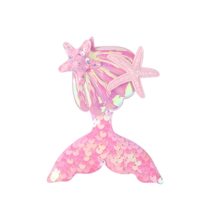 Detailed view of pink mermaid tail hair clip with sparkling sequins and starfish decor