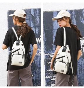 Detail showing the back and side view of white Oxford fabric sports crossbody chest bag