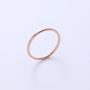 Minimalist ultra-thin titanium steel ring in rose gold finish shown on a light gray background