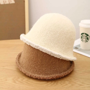 Detail of warm lamb wool bucket hats in beige and brown colors with plush texture