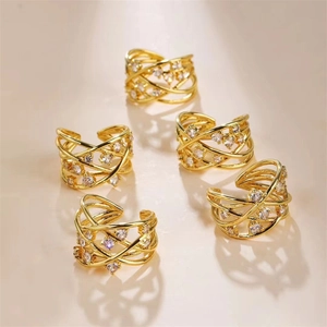 Macro detail of a 5-piece gold-plated zircon ring set with a layered crossover design