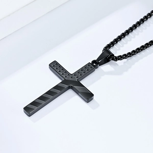 Detail of black stainless steel cross pendant with American flag stars and stripes relief