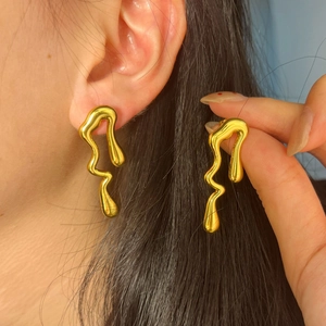 Modern gold irregular lava earrings featuring streamlined liquid design and mirror finish