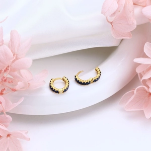 Elegant gold huggie hoop earrings with deep blue square-cut cubic zirconia crystals