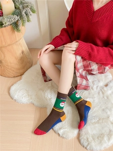Detail of Christmas knit socks with Santa pattern and festive Happy Holidays text