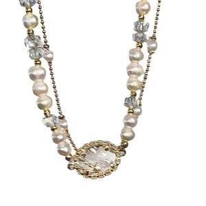 Double-layered oval pearl and crystal necklace with a golden vintage pendant