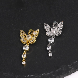 Detailed view of butterfly pendants in gold and silver finish with zircon tassel