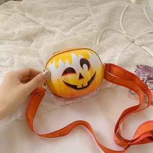 Detailed close-up of a pumpkin-shaped yellow crossbody bag with themed shoulder strap