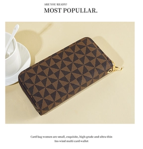 Detailed macro view of brown long wallet with geometric patterns and golden zipper hardware