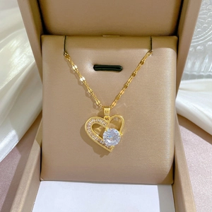 Detailed macro view of gold heart necklace with crystals in a brown gift box