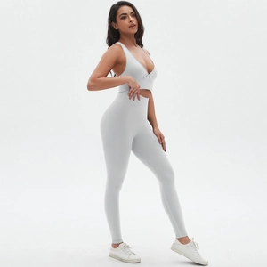 Detail view of light grey seamless cross-back sports bra and high-waisted yoga leggings