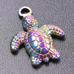 Macro shot of iridescent rainbow sea turtle pendant with hexagonal shell textures