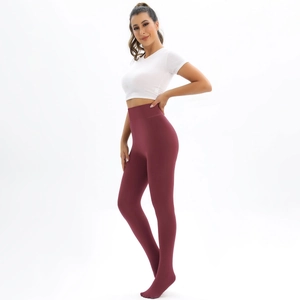 Detail of burgundy high-waist thermal leggings showing the elastic slim-fit waistband