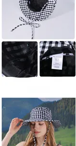 Detail of adjustable strap and gingham pattern on a wide-brim outdoor sun hat