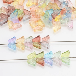 Colorful gradient butterfly glass beads for DIY jewelry making displayed on metal pins