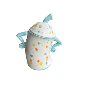 Handcrafted white ceramic jar with colorful polka dots and unique curved handles
