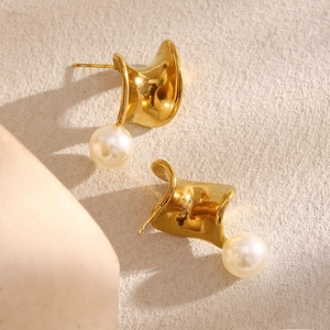 Detailed close-up of distorted gold stainless steel stud earrings with round white pearl