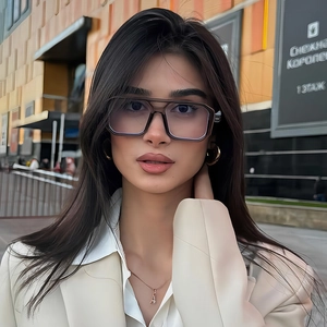 Modern double bridge aviator sunglasses with transparent grey frames in outdoor setting