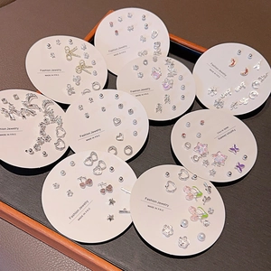 Close-up of seven-pair Korean earring sets featuring zircon stars and pearl bows