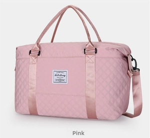 Detail view of pink quilted travel bag with waterproof texture and metal buckle