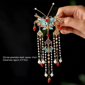 Detail view of Chinese butterfly hair clip with blue enamel, tassels and pearl beads
