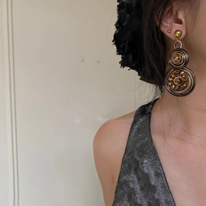 Vintage woven crystal double disc earrings in antique gold finish on female model