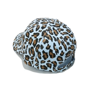 Detail view of the adjustable back closure on a leopard print cotton baseball cap