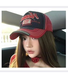 Detail of red and black vintage baseball cap with 3D Hawaii embroidery in a car