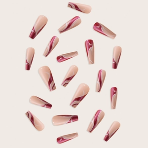 Detailed view of long French style marble pattern press-on nails with red and nude tones