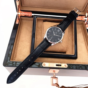 Detail of luxury men quartz watch with black leather strap in a premium wooden gift box