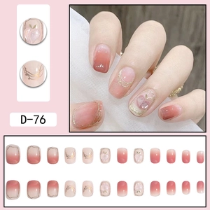 Pink gradient press-on nails with peach patterns and gold line details set for women