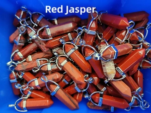 Bulk collection of hexagonal red jasper crystal pendants with silver metal clasps