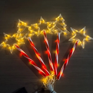 Solar Christmas path lights with star and tree shapes on red white striped poles