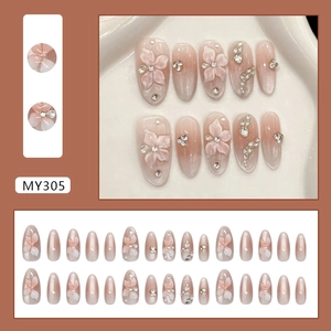 Nude pink cat eye press-on nails with 3D floral accents and elegant pearls